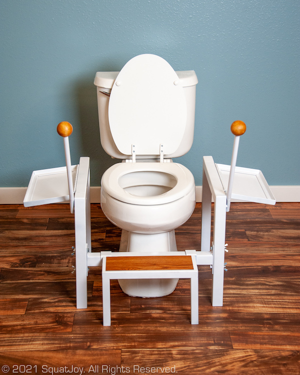 Squatjoy squatting platform around a western raised toilet, configured for sitting.
