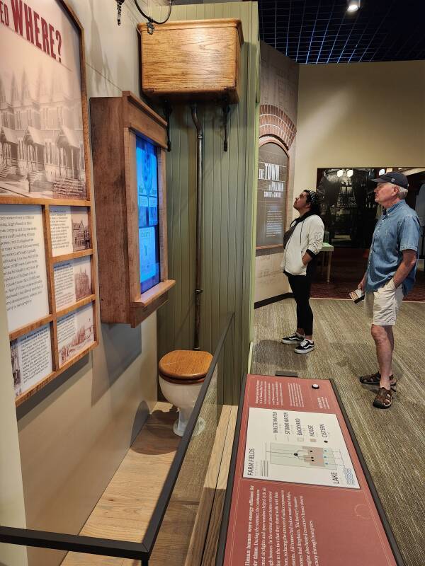 Toilet and elevated flush tank.