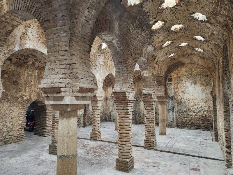 Warm Room with columns topped by horseshoe arches, supporting a vaulted ceiling with star-shaped skylights.