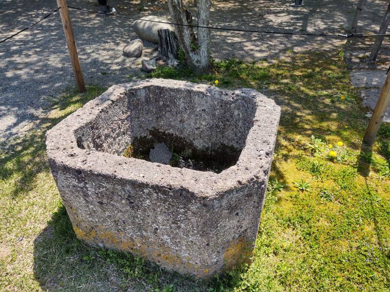 Stone water tank next to a cistern or uma arai-ishi within the inner bailey of Aizu-wakamatsu castle.