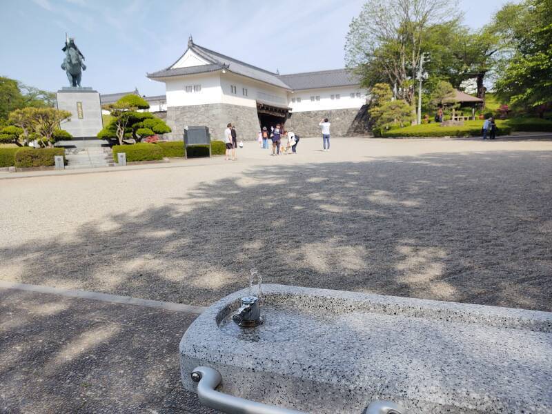 Water fountain and statue of Mogami Yoshiaki within the Yamagata Castle walls.