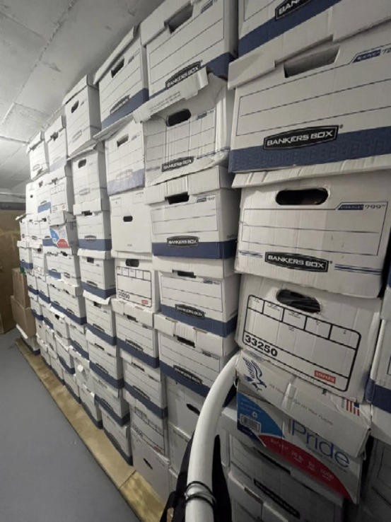 Boxes of highly sensitive U.S. Government documents piled in a storage room at a tacky golf resort.