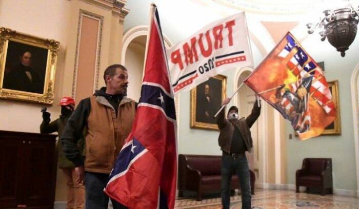 Supporters of Republican President Donald Trump storm the US Capitol carrying Confederate flags and smearing their poop.