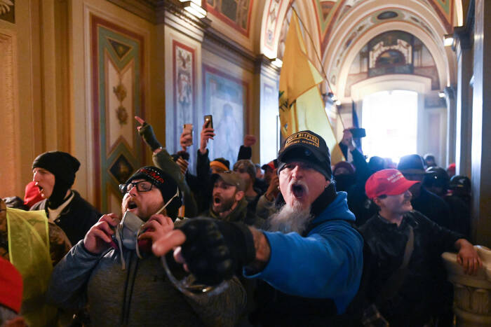 Supporters of Republican President Donald Trump storm the US Capitol carrying Confederate flags and smearing their poop.