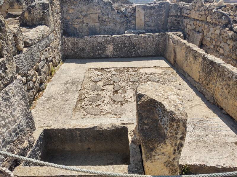 Multi-person latrine with cleaning water tank in Volubilis, a ruined Berber-Roman city in northern Morocco.